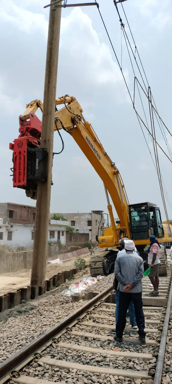 Pile driving beside a railway track, Uttar Pradesh, 2026, infrastructure work by M/S VKJJVBBNINFRA