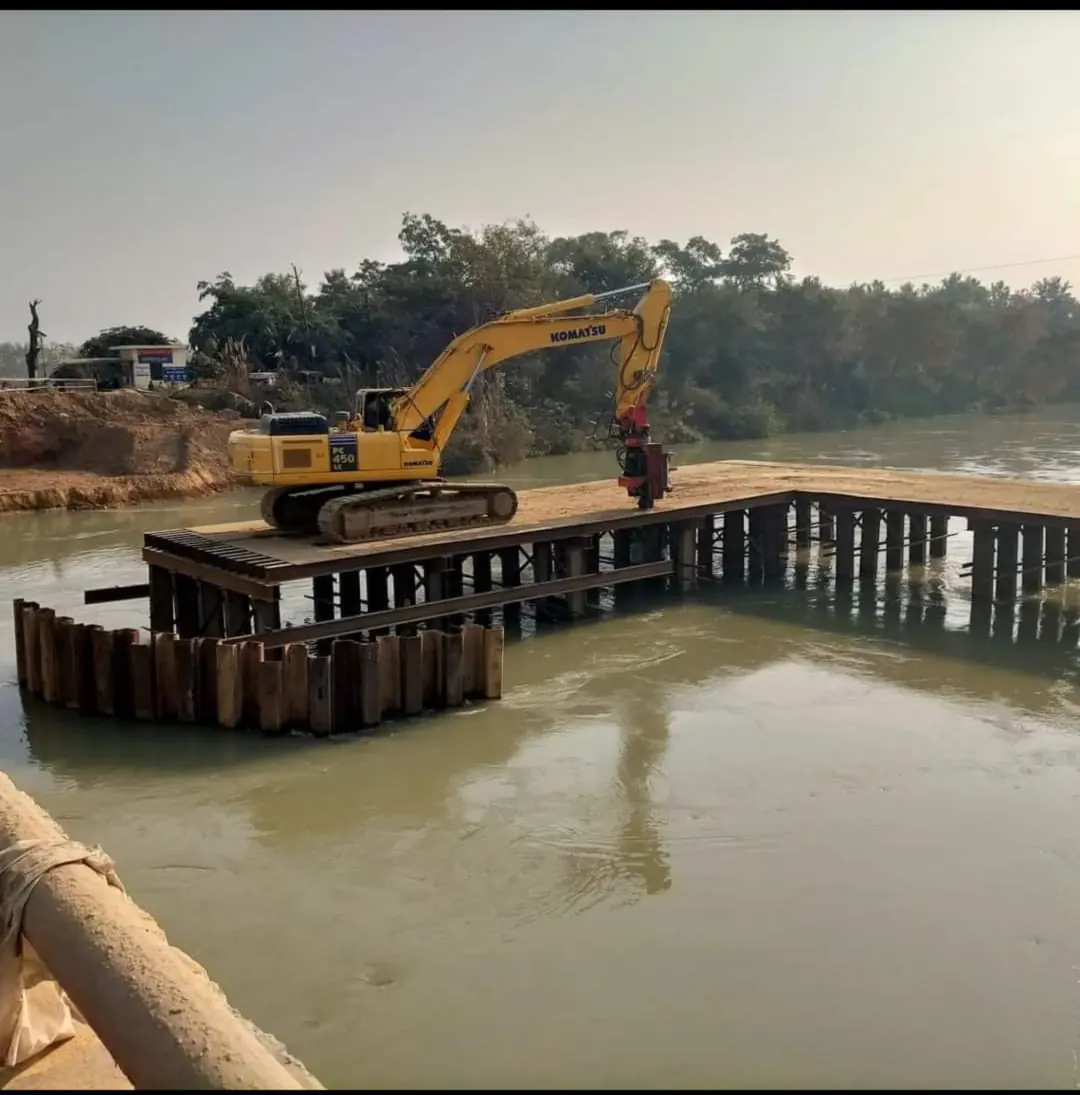 Excavator on a river platform, Uttar Pradesh, 2026, infrastructure work by M/S VKJJVBBNINFRA