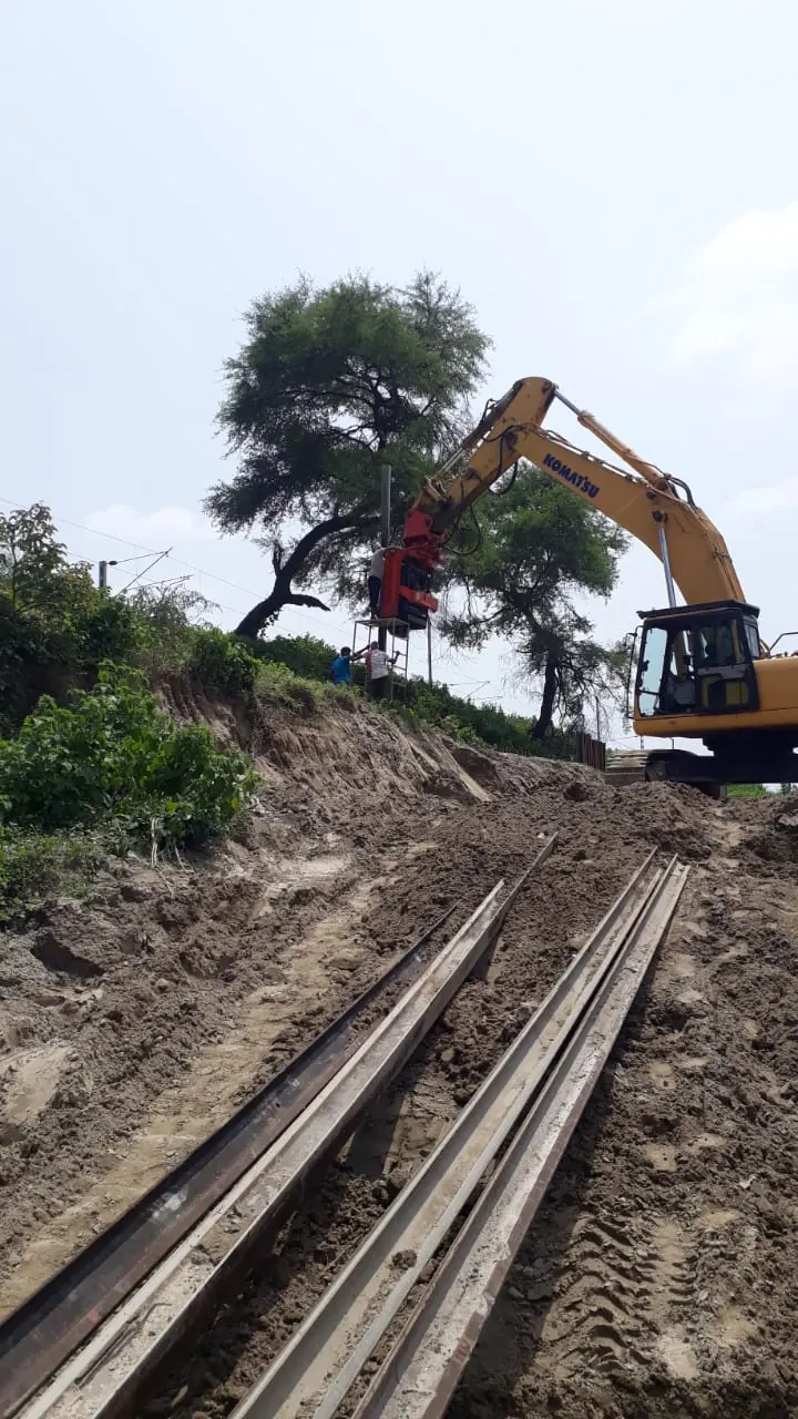 Excavator beside railway lines, Uttar Pradesh, 2026, infrastructure work by M/S VKJJVBBNINFRA