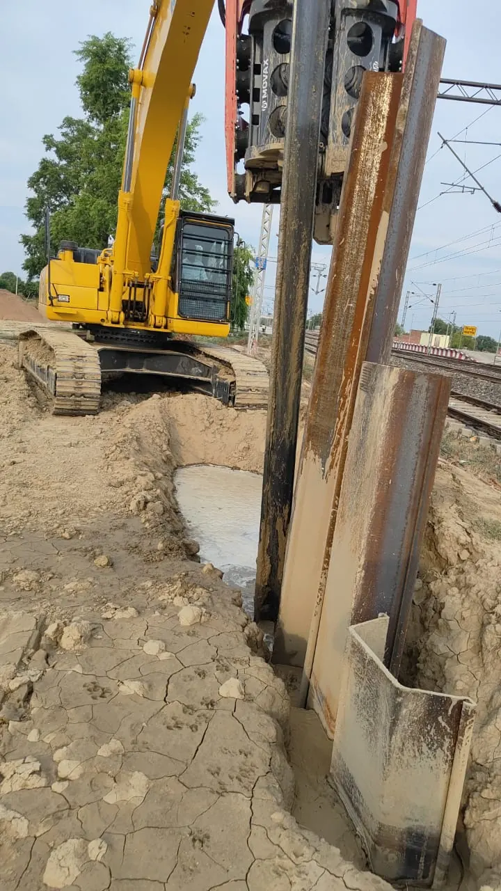 Sheet piles along a track, Uttar Pradesh, 2026, infrastructure work by M/S VKJJVBBNINFRA
