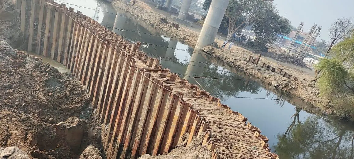 Sheet-pile wall along a water edge, Uttar Pradesh, 2026, infrastructure work by M/S VKJJVBBNINFRA