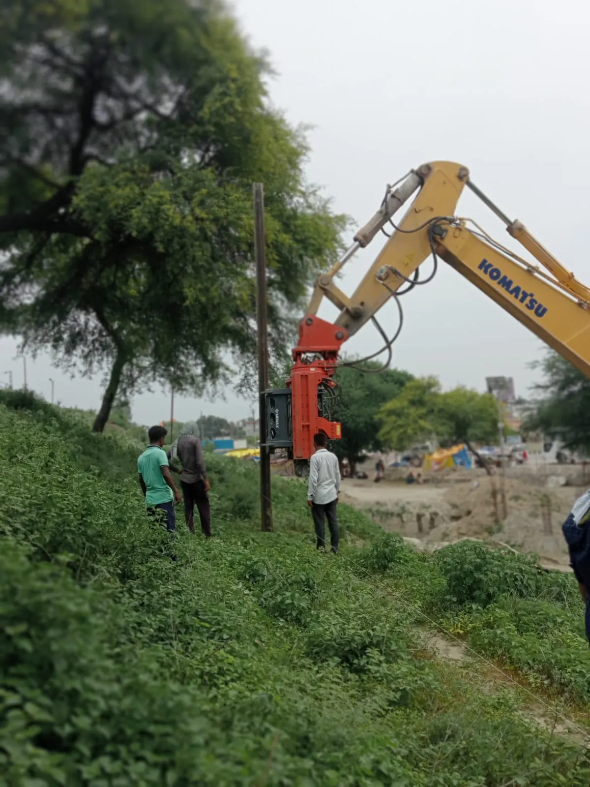 Pole driving in open ground, Uttar Pradesh, 2026, infrastructure work by M/S VKJJVBBNINFRA