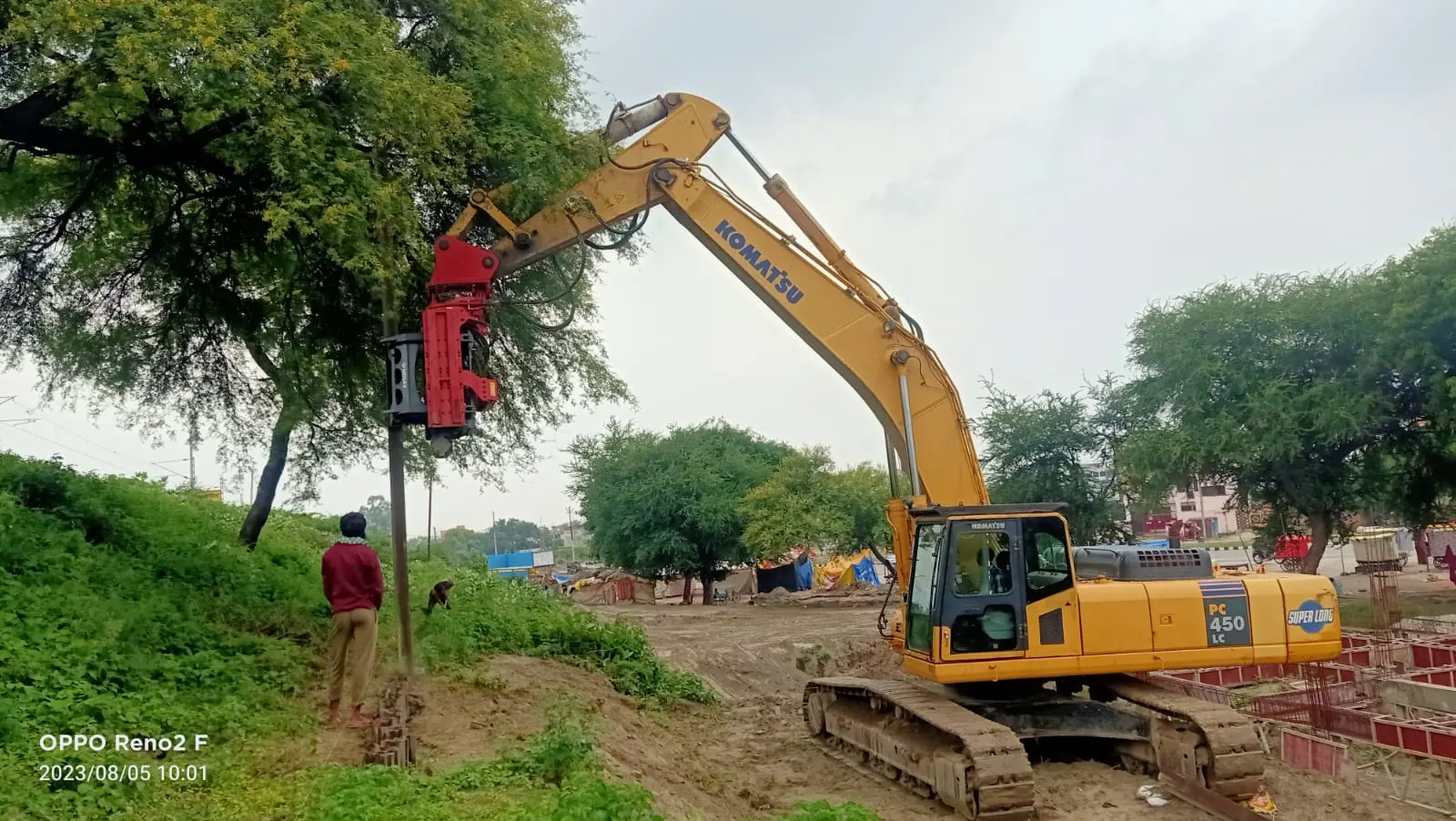 Pile driving along a green edge, Uttar Pradesh, 2026, infrastructure work by M/S VKJJVBBNINFRA