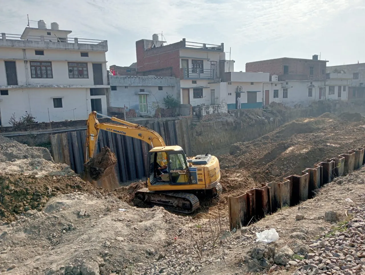 Excavation beside houses, Uttar Pradesh, 2026, buildings work by M/S VKJJVBBNINFRA
